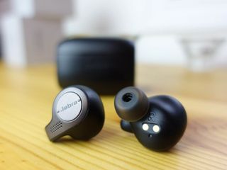 Jabra Elite 65t earbuds with case in the background