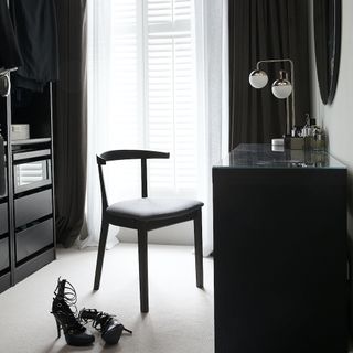 Monochrome dressing room with chair and high heels