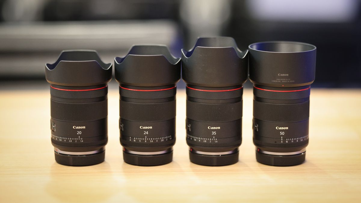 Canon's hybrid line of f/1.4L lenses (20mm, 24mm, 35mm and 50mm) on a wooden surface