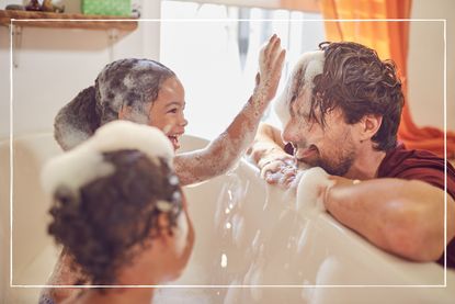 Kids in bath splashing parent with bubbles