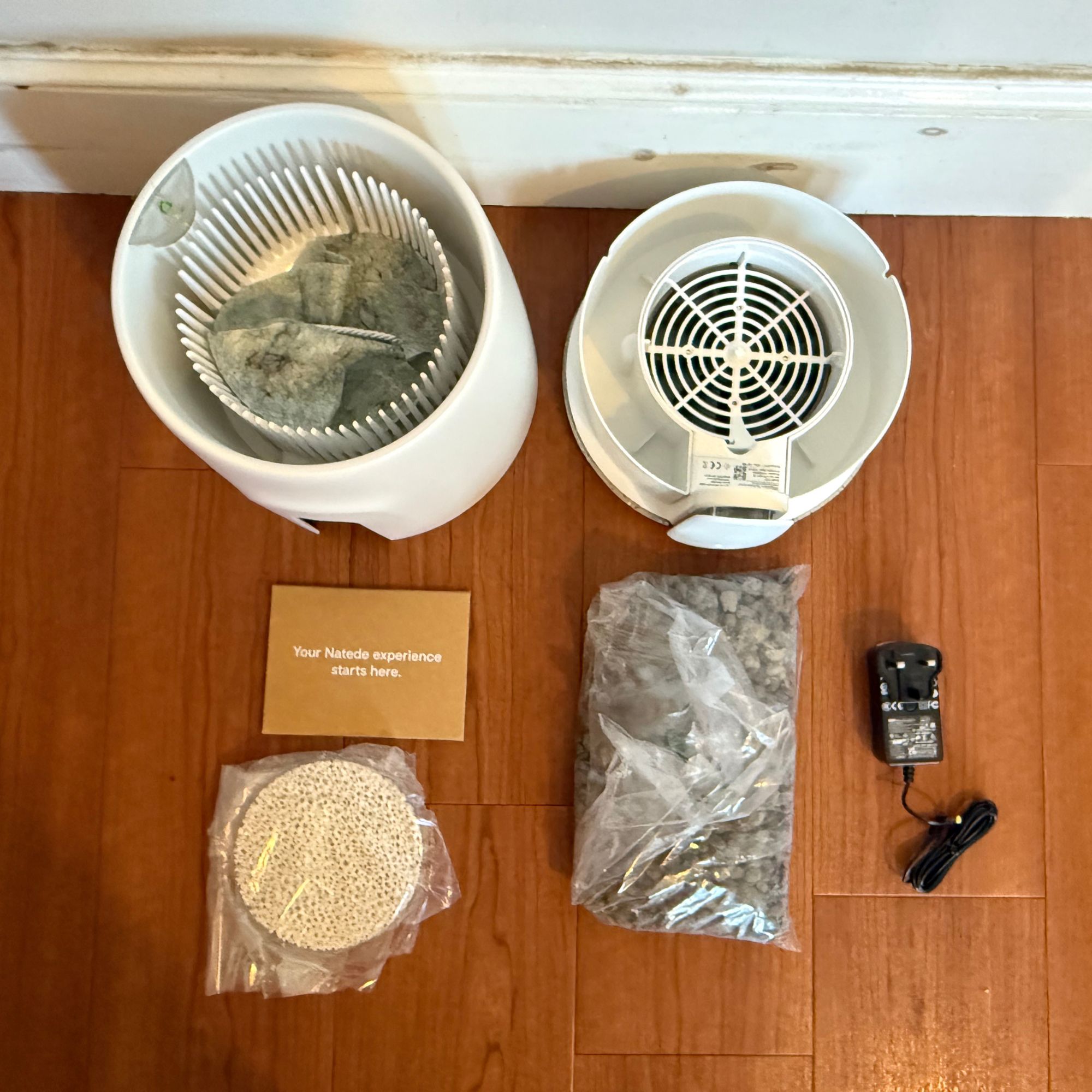 components of the Vitesy Natede Smart air purifier laying on the floor