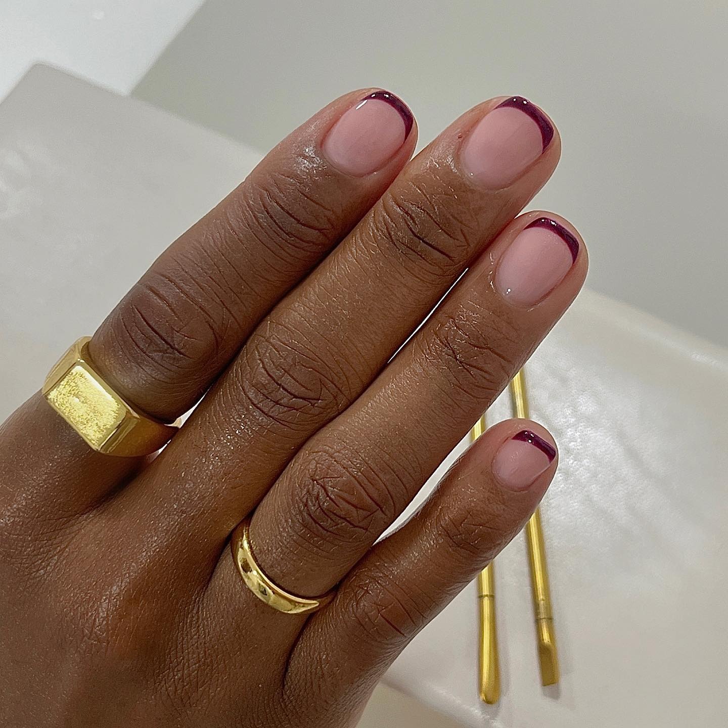 A square, burgundy French tip manicure