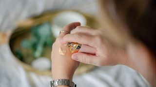 woman applying makeup to hand