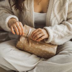 Close up of woman's hands unpacking holiday gift