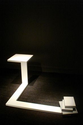 A white table connected with a lower level to another section.