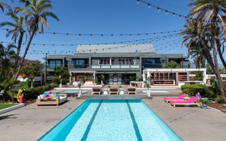 a long shot showing the Winter Love Island villa and pool, surrounded by palm trees