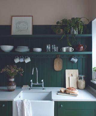 Small modern farmhouse kitchen painted dark creen with shaker kitchen cabinets and open shelving