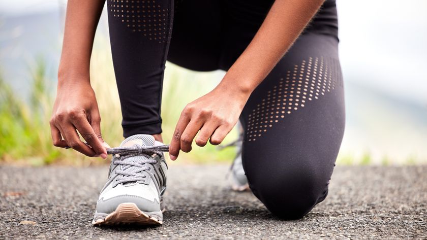 a woman tying her running shoe lace