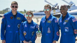 (L-R) Canadian Space Agency astronaut Artemis II Mission Specialist Jeremy Hansen, NASA astronaut and Artemis II Mission Specialist Christina Koch, NASA astronaut and Artemis II Commander Reid Wiseman and NASA astronaut and Artemis II pilot Victor Glover look on during a welcome ceremony ahead of the Artemis II April 1 launch at Kennedy Space Center in Florida on March 27, 2026. NASA and Canadian Space Agency astronauts assigned to the Artemis II mission arrive at Kennedy Space Center in Florida on March 27, 2026, to begin final pre-launch preparations for the first crewed lunar flyby in the Artemis program. The journey, set to last around 10 days, will take the astronauts on a loop around the Moon, though they will not land on its surface. The crew comprises the first woman, the first person of color and the first non-American to take part in such a journey. (Photo by Miguel J. Rodriguez CARRILLO / AFP via Getty Images)