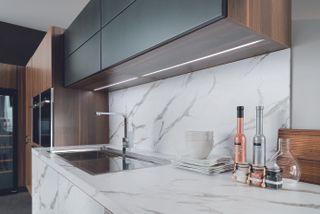 Kitchen with marble look cabinets, counter and backsplash