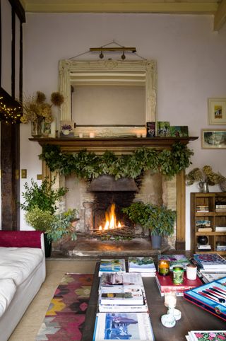 Large fireplace with evergreen Christmas decorations