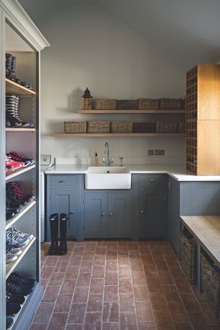 boot room with butlers sink, baskets and shoe storage