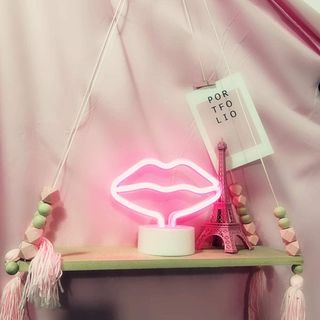 Neon lips lamp on table