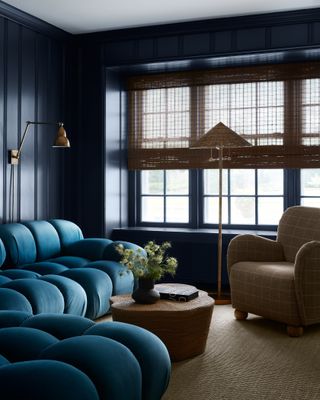 Dark blue living room with bamboo curtains