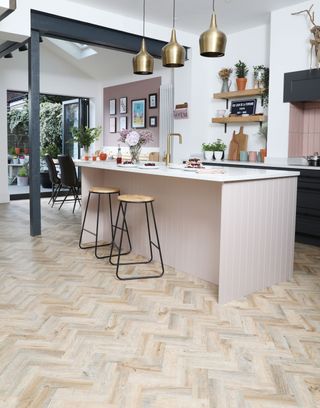 Steve and Katelin Haworth’s industrial grey kitchen has been lifted with a pop of blush pink