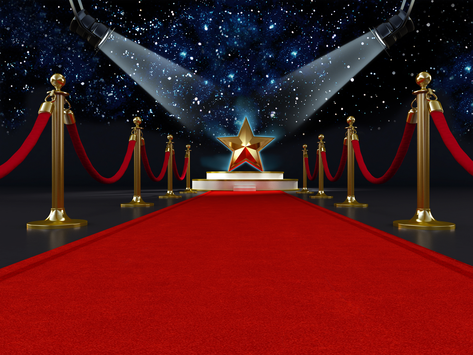 Red carpet with a star shape on the platform lit by two spotlights.