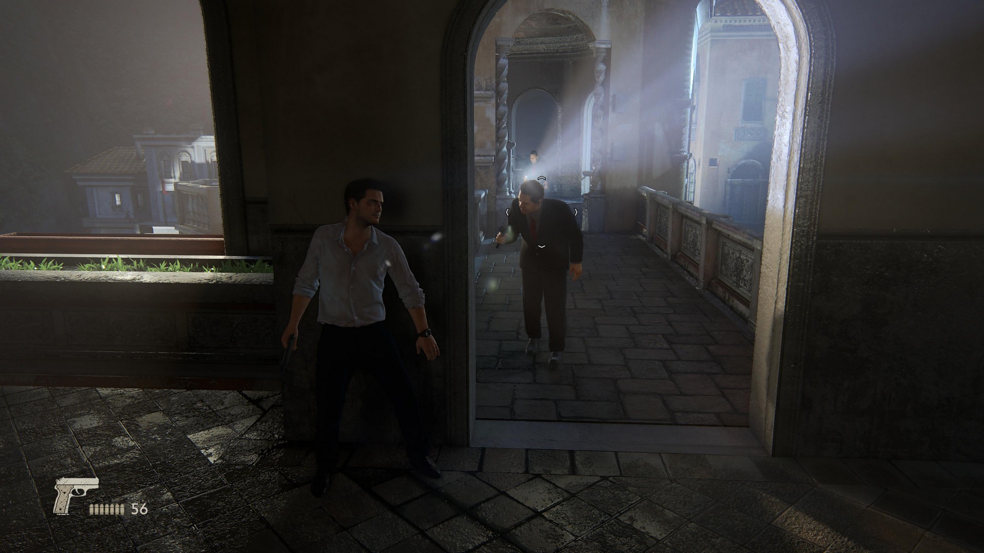 Nathan Drake hides from a guard around a corner, in Uncharted 4, from the PS5's Uncharted: Legacy of Thieves Collection