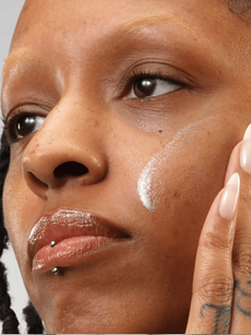 Model applying a moisturiser to their face