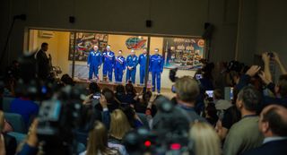 Expedition 41 prime crew members Flight Engineer Barry Wilmore of NASA, far left, Soyuz Commander Alexander Samokutyaev of the Russian Federal Space Agency (Roscosmos), second left, and Flight Engineer Elena Serova, of Roscosmos, center, pose for a pictur