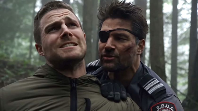 Unmasked Slade Wilson holding Oliver's arm behind his back painfully in Arrow