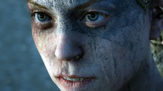 Hellblade: Sensua's Sacrifice hero character Senua staring at the viewer. Her face is covered in warpaint