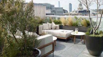 Urban gardening ideas with white furniture and plenty of plants 