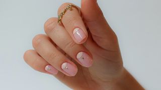 Squoval nails in neutral colour with nail art