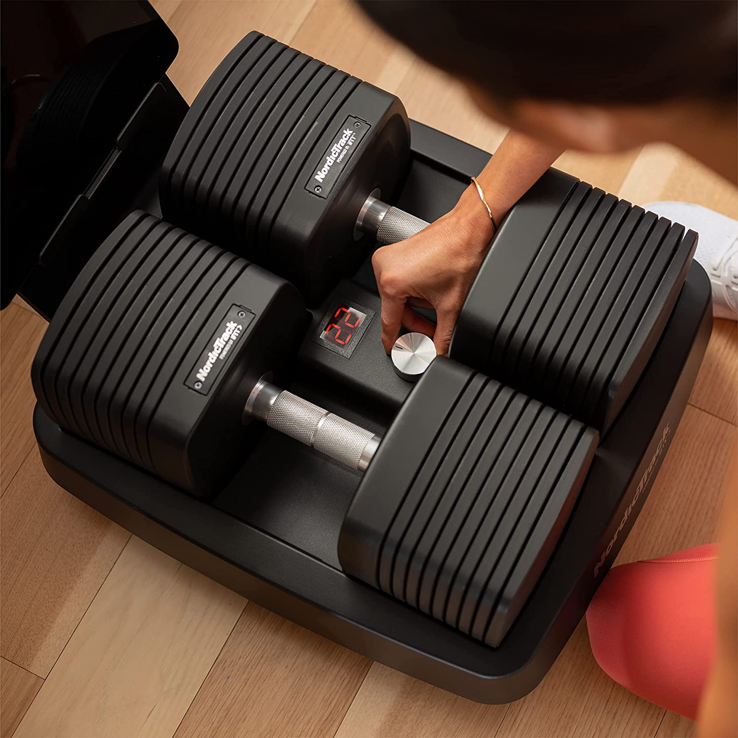 a photo of the NordicTrack iSelect Adjustable Dumbbells in their rack