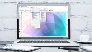 A laptop running inkscape on a desk