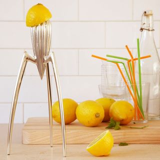 lemons and lemons squeezer and glass and straws