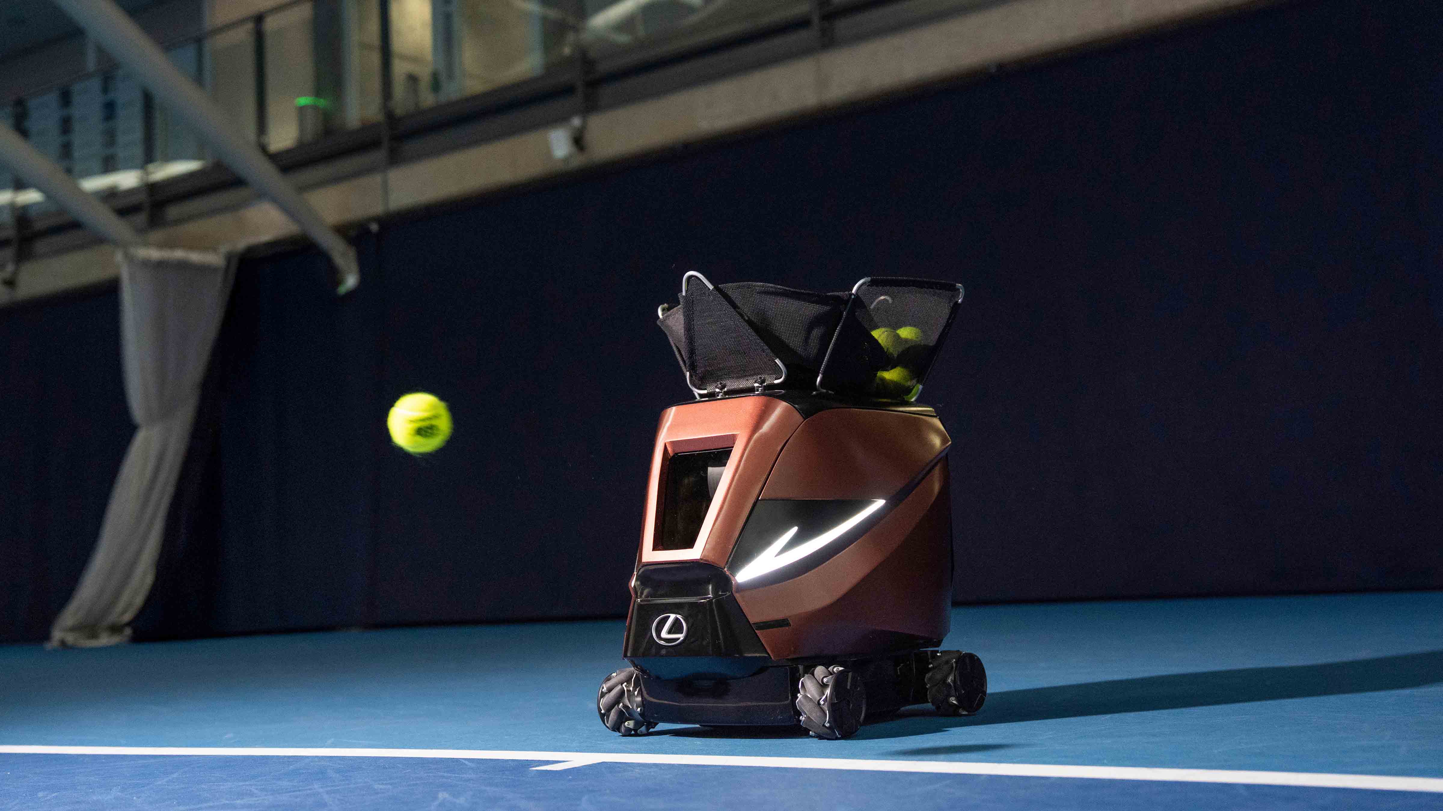A tennis ball being shot by the Lexus tennis machine.