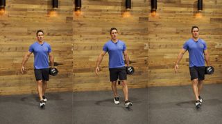 Don Saladino demonstrates the suitcase carry exercise with dumbbells