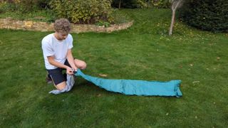 Man inflating Therm-a-Rest NeoAir Venture sleeping pad