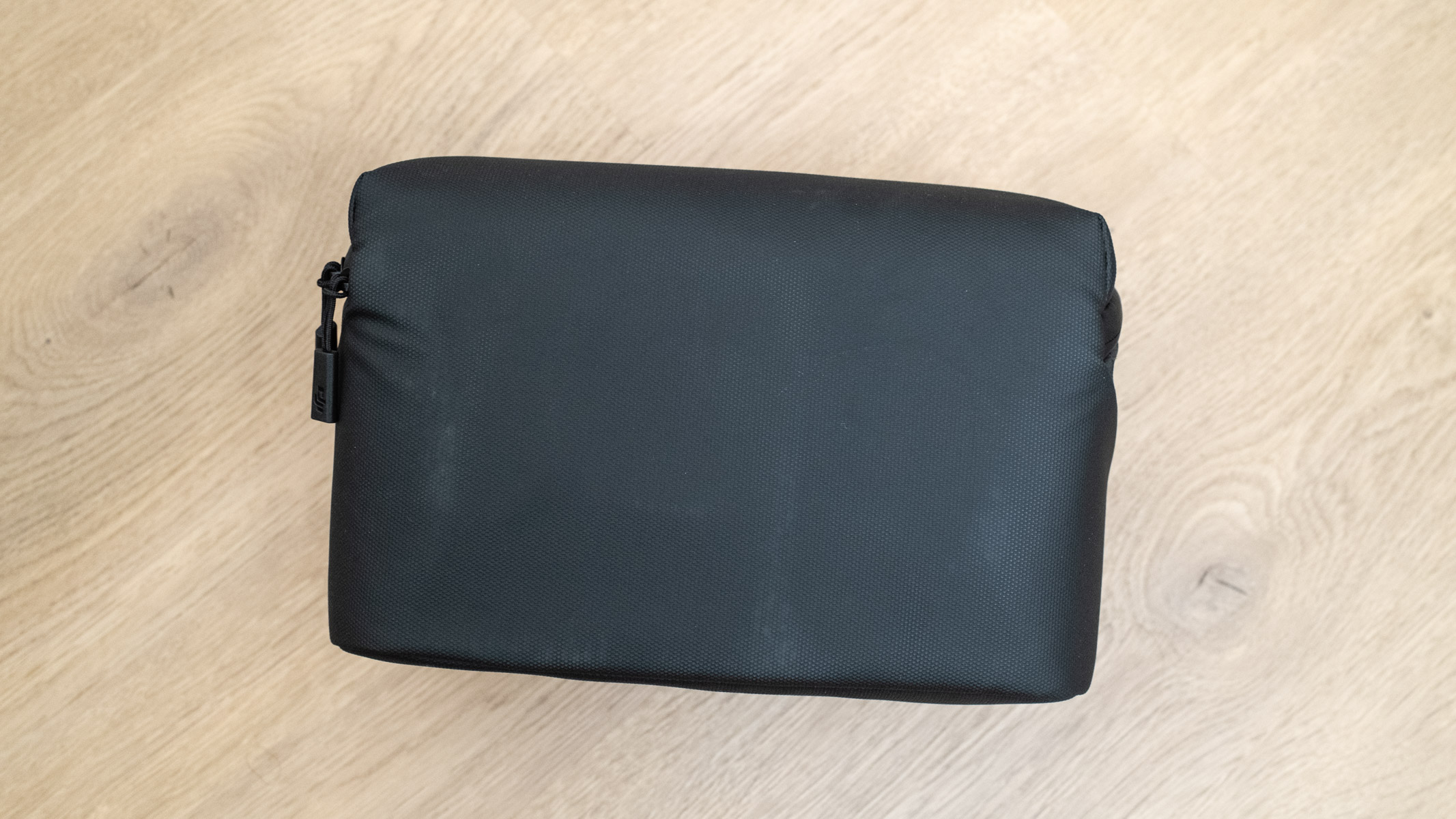 DJI Mini 5 Pro carry bag on a wooden floor