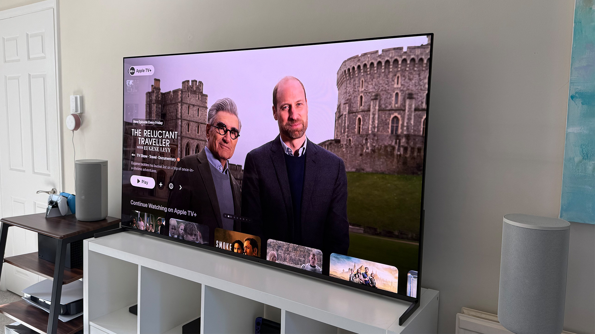 Apple TV+ TV streaming service on TV in living room, on screen is The Reluctant Traveller
