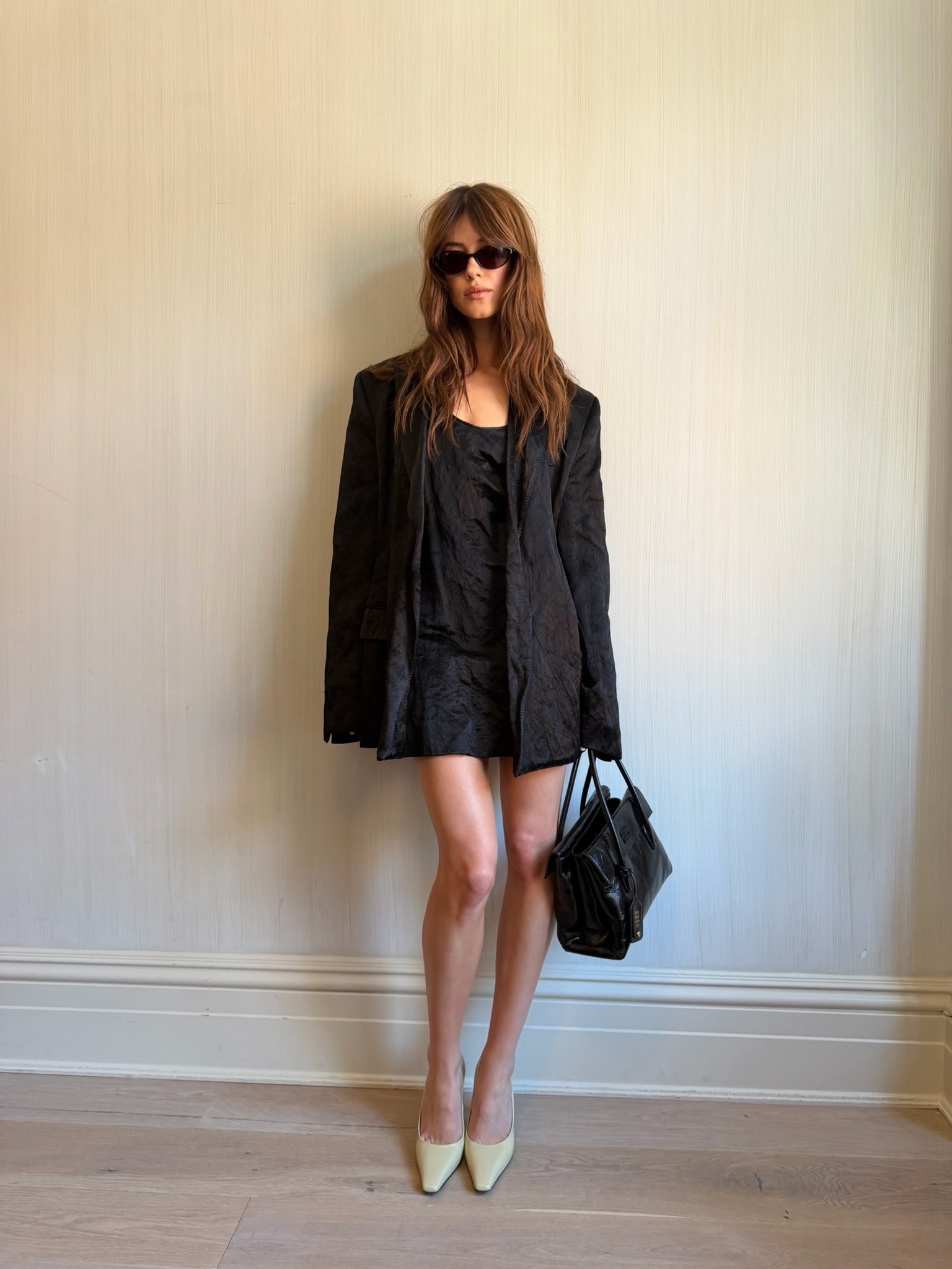 Daisy Edgar Jones wears a black linen minidress with a matching blazer and beige square-toe heels.