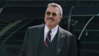 Frank Reagan in sunglasses outside smiling in Blue Bloods Season 13