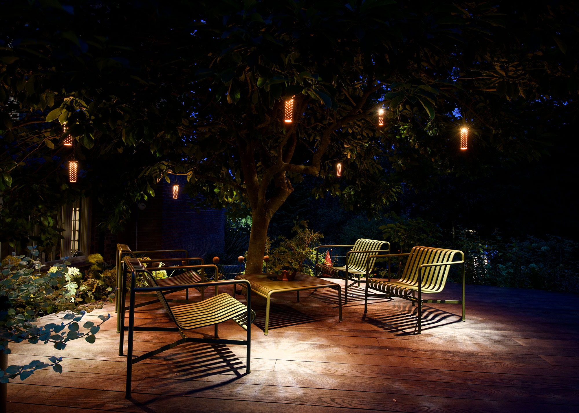 outdoor seating area with suspended tree lighting