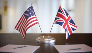 Mini US and UK flags on the desk of an ambassador 