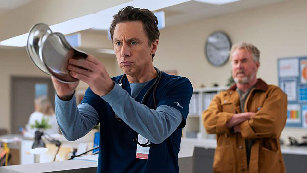 J.D. banging two stool pans together as Dr. Cox watches in Scrubs season 10 episode 8