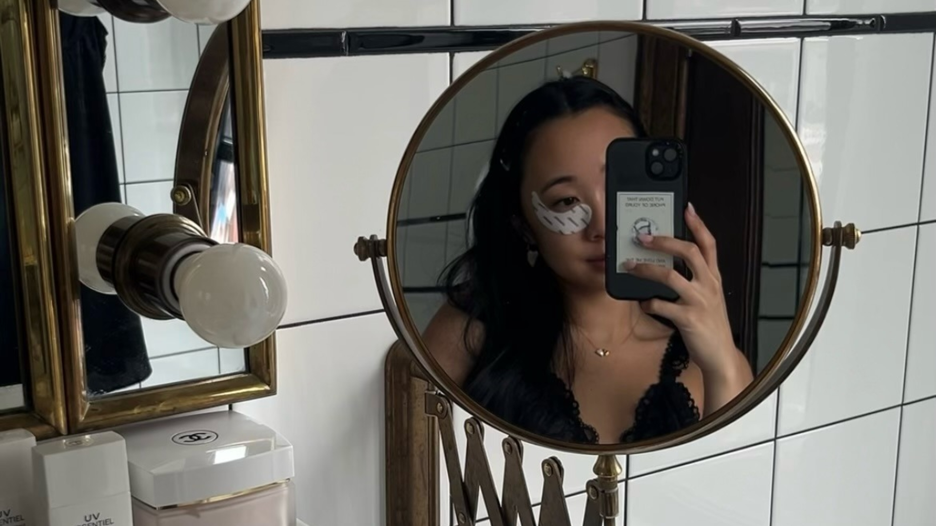 A woman wears skincare eye patches