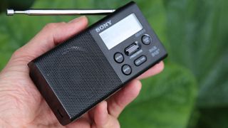 a close up of the sony xdr-p1 dab radio being held in someone's hand