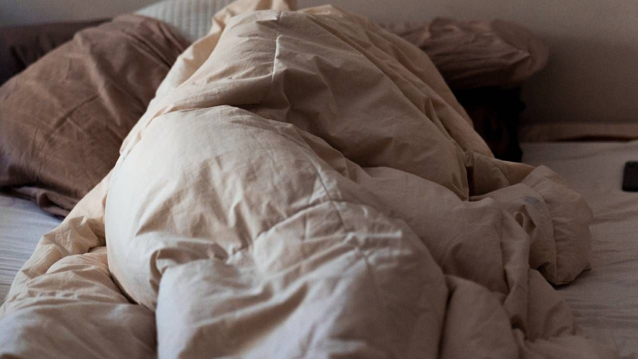 Wrinkled duvet on a bed, sleep &amp; wellness tips