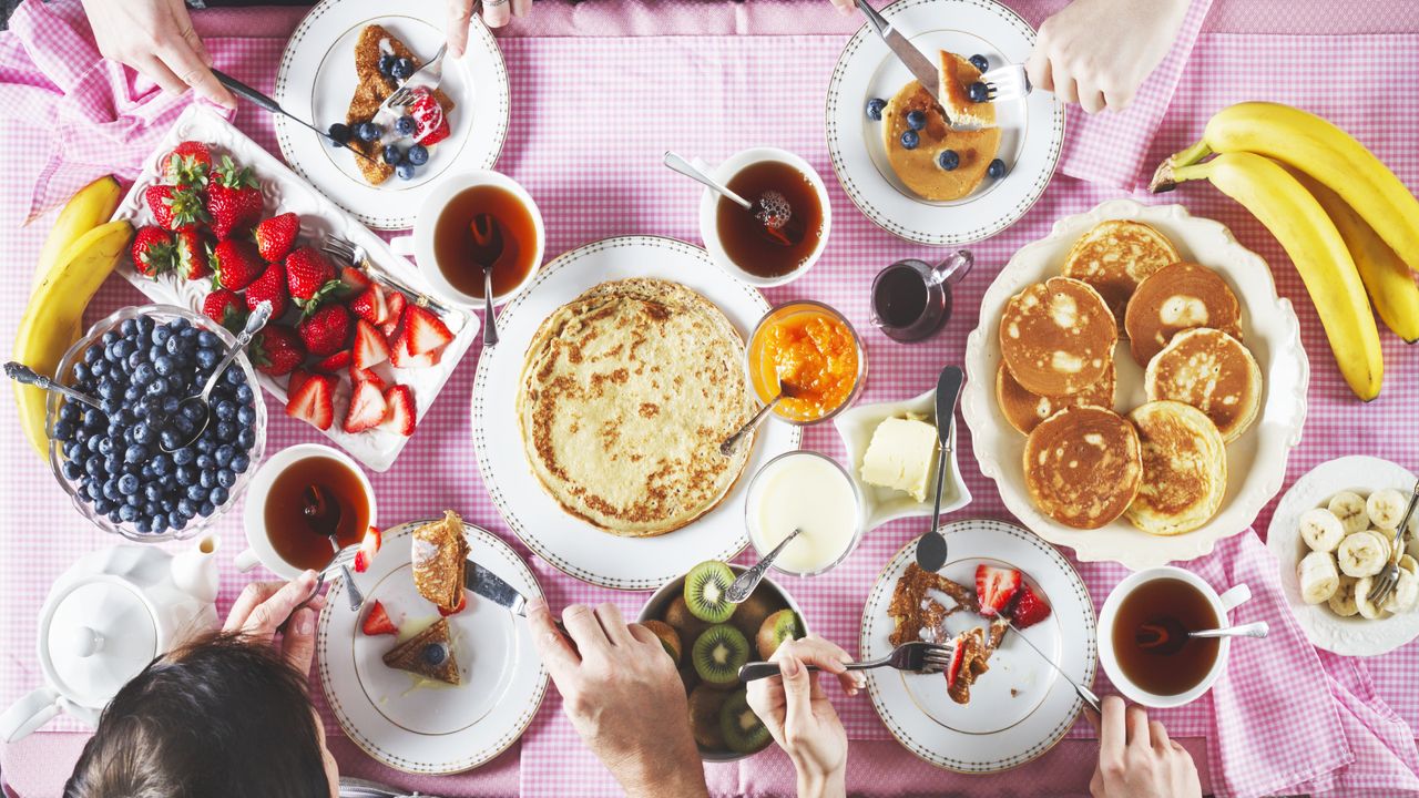 pancake recipes shown on a spread full of fruit and different pancake styles