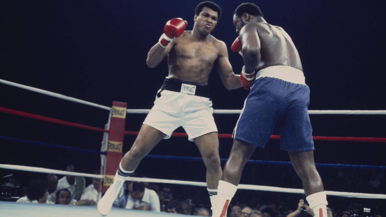 Boxers Muhammad Ali, left, and Joe Frazier face off in the boxing ring.