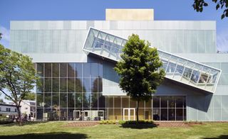 Building with exterior glass sloped walkway