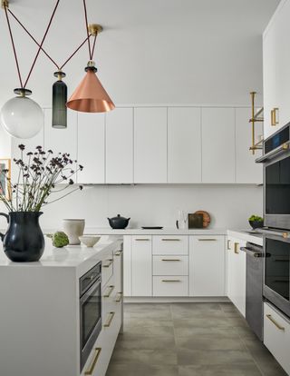 a modern white kitchen with mix and match lighting