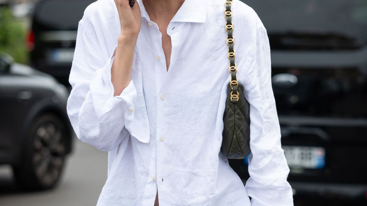 Liu Wen wears a white shirt, blue pants and olive green Chanel bag