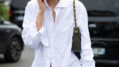 Liu Wen wears a white shirt, blue pants and olive green Chanel bag