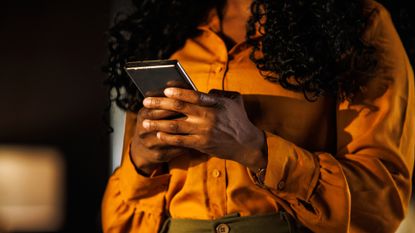 Black woman reads phone